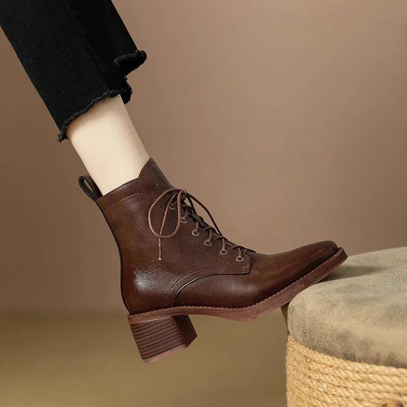 Women's black and brown pointed-toe ankle boots with a 5.5cm heel on a plain background