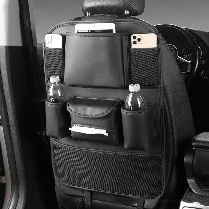 Leather car seat back storage bag in a choice of colours, shown hanging from a vehicle headrest.
