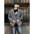 Men's loose fit V-neck cardigan sweater in a solid colour on a hanger.