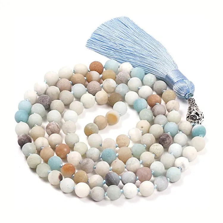 Long multicoloured agate tassel necklace with geometric beads and a flowing pendant.