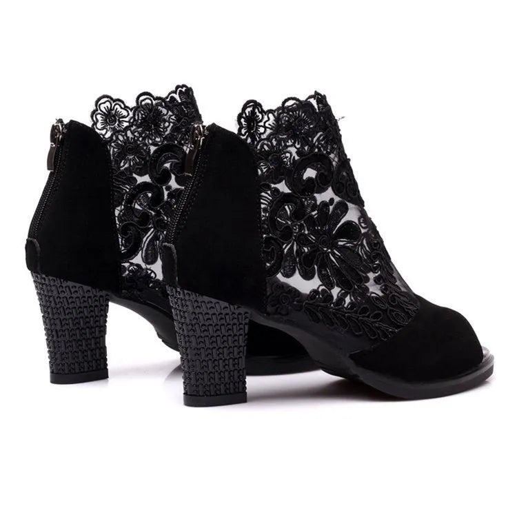 Black women's lace gladiator sandals with a zip closure, floral pattern, and a square high heel on a rubber outsole.
