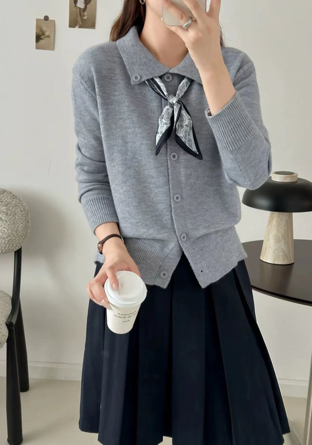 Ladies' grey lapel scarf cardigan sweater on a hanger