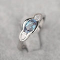 Geometric ellipse zircon ring in white gold finish on a copper band.