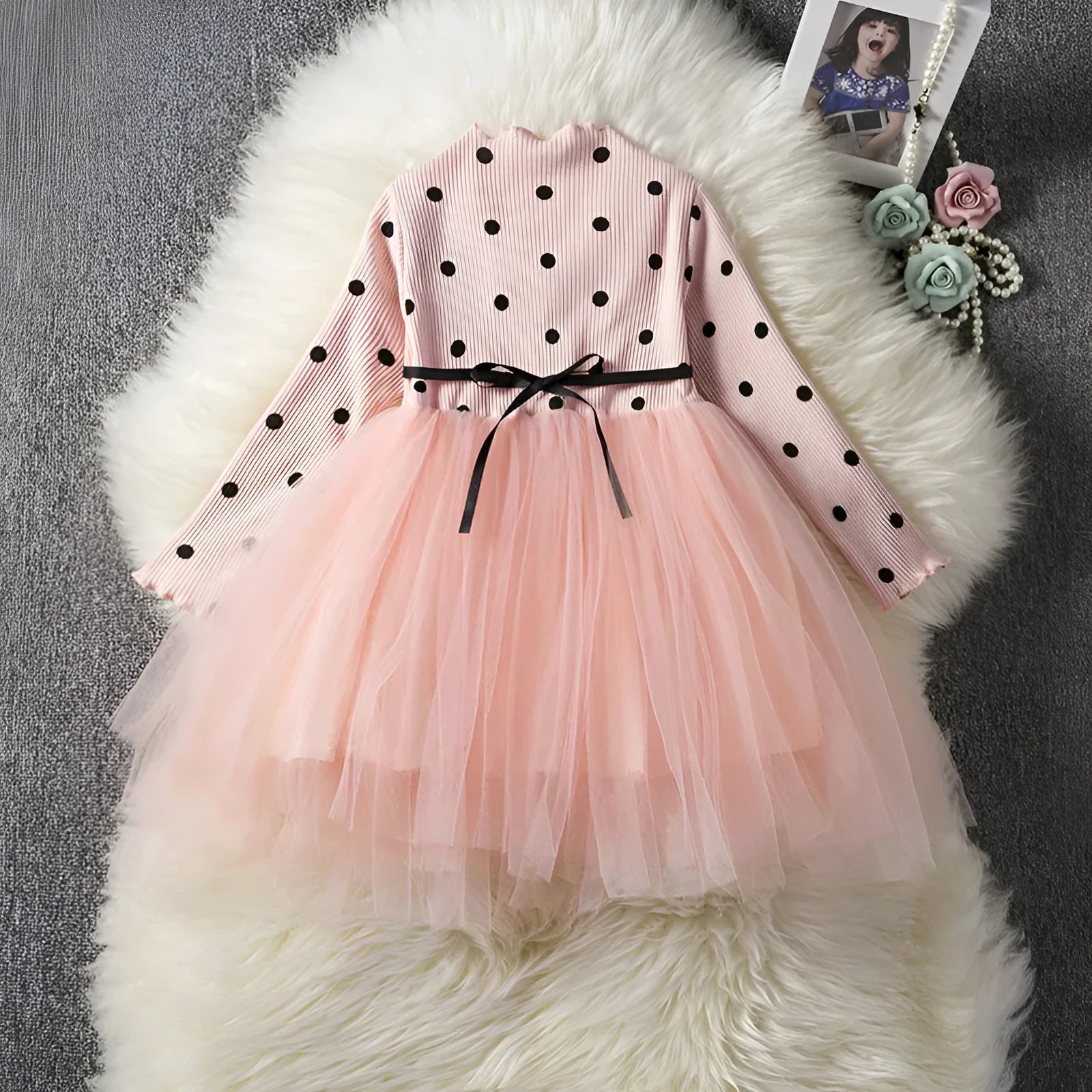 Baby girl in a long sleeve black lace tutu dress, suitable for christenings and parties.