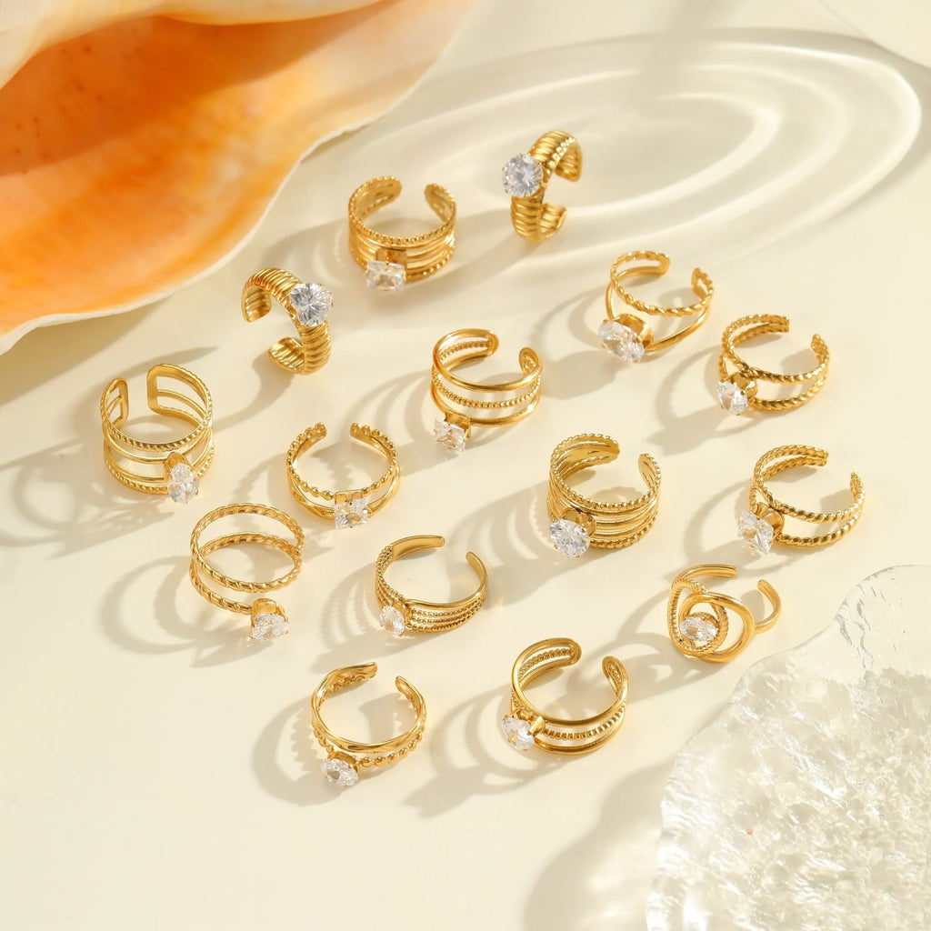 Gold-inlaid zircon geometric stainless steel ring with open mouth design on a white background.