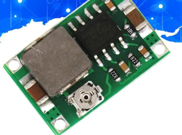 Mini-360 green DC-DC buck converter step down power module on white background