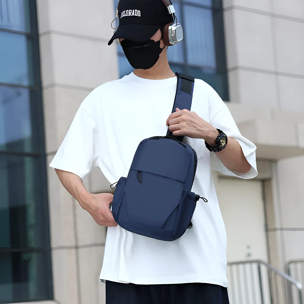 Mens grey waterproof chest bag showing front compartment and shoulder strap