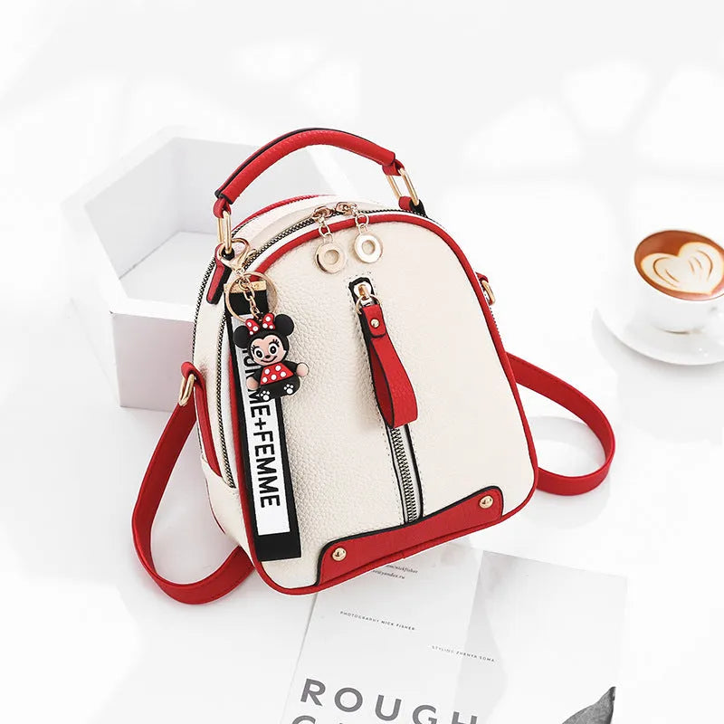 Fashion backpack for women in PU leather oval shape with double shoulder straps and car suture detail
