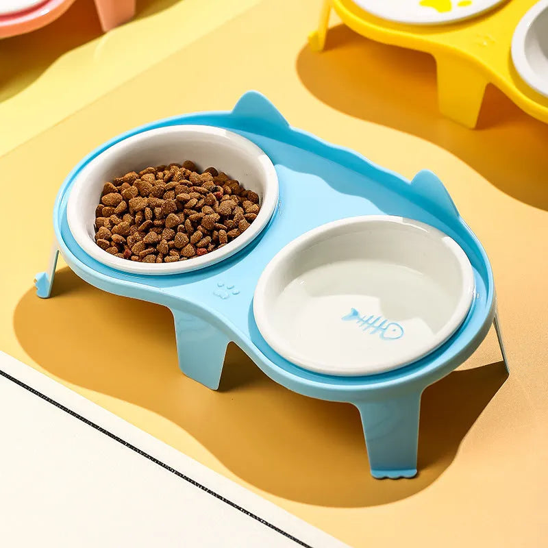 Ceramic cat bowl set with elevated tilted feeding stand in blue, pink, white, and yellow colour options