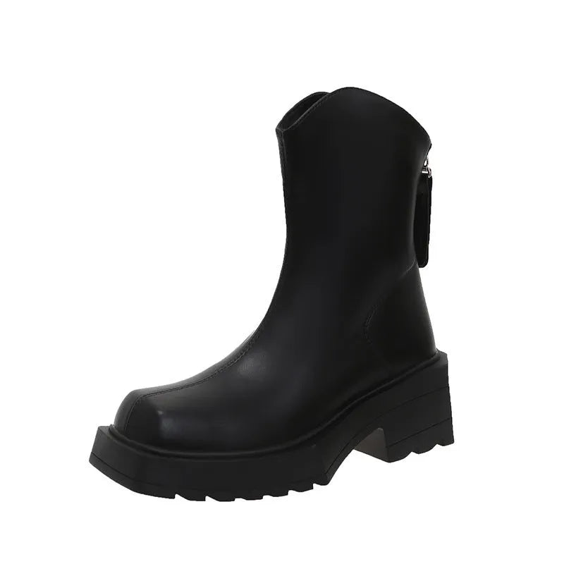 Black women's platform Martin ankle boots with a square toe and high heel on a white background