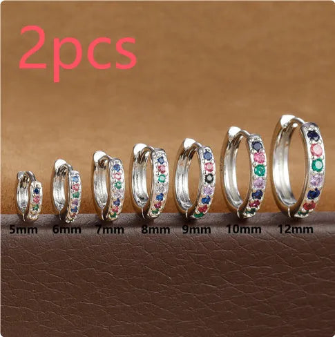 Circle-shaped zircon stud earrings in gold, rose gold, or silver colour on a white background.