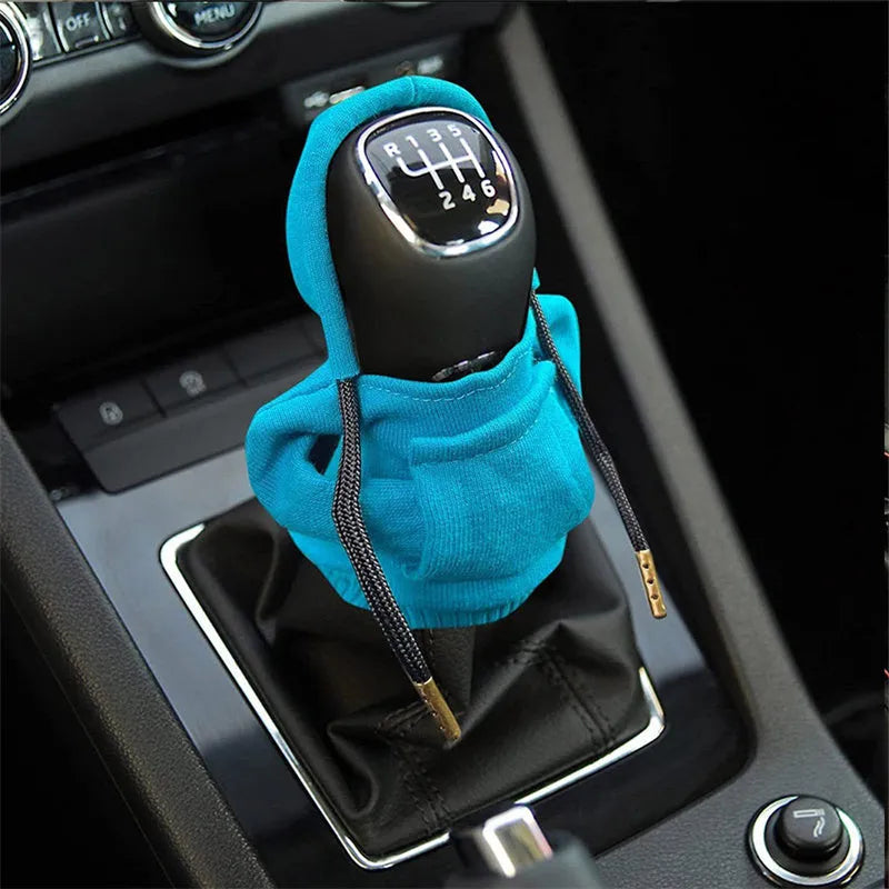 Universal cotton gear knob cover hoodie in blue with adjustable drawstring on a car shift knob