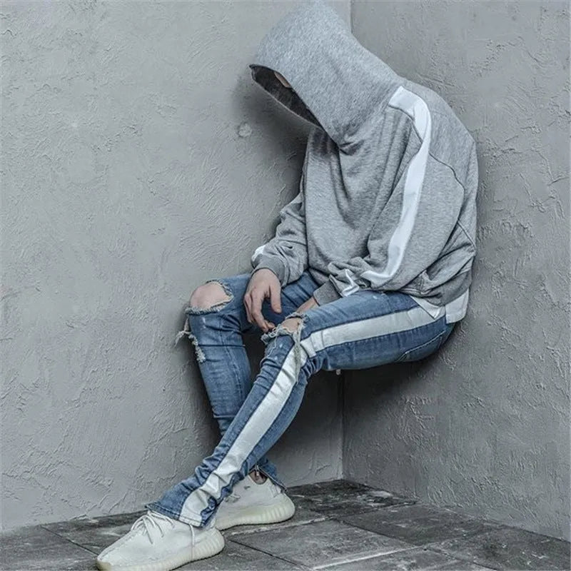 Men's ripped cotton denim jeans in black with distressed detailing, front view