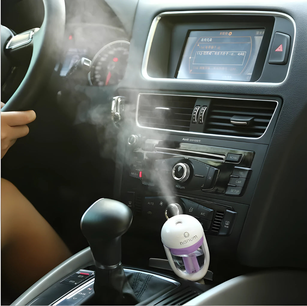Compact portable car humidifier and essential oil diffuser unit in blue, green, pink, or purple.