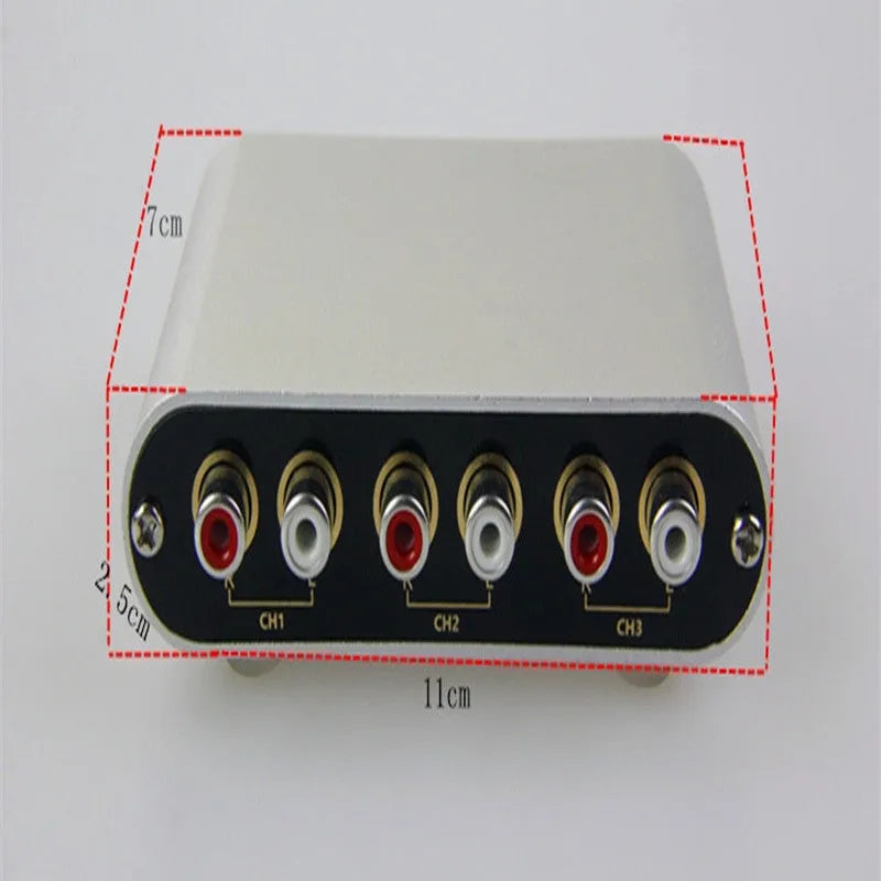 Silver aluminium audio source switch unit with front-panel buttons and infrared remote control.