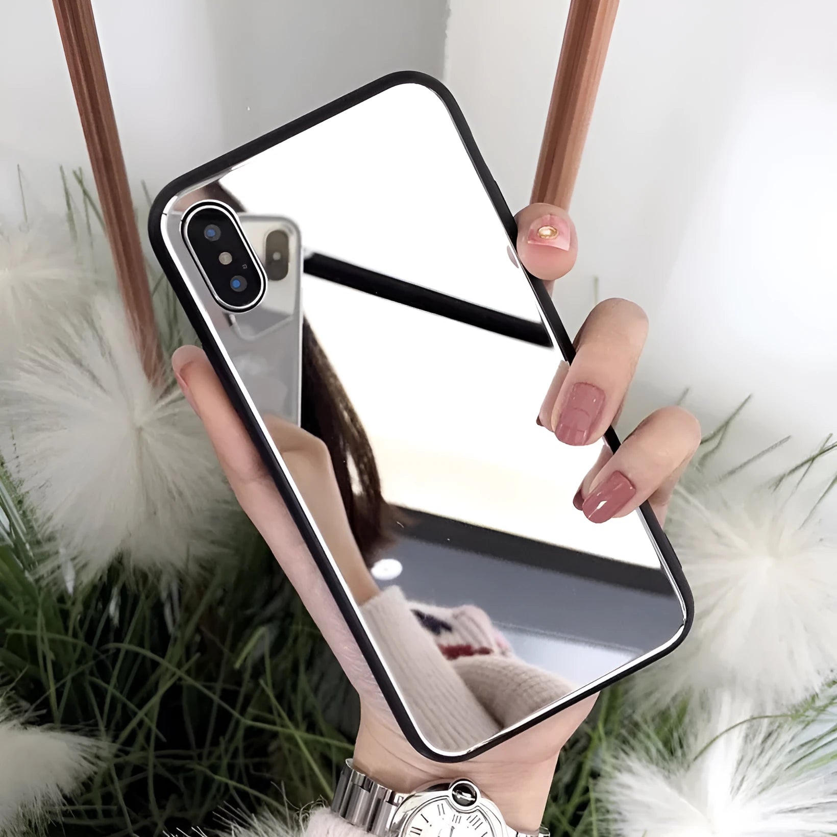 Black iPhone mirror case showing reflective surface on back, compatible with multiple iPhone models