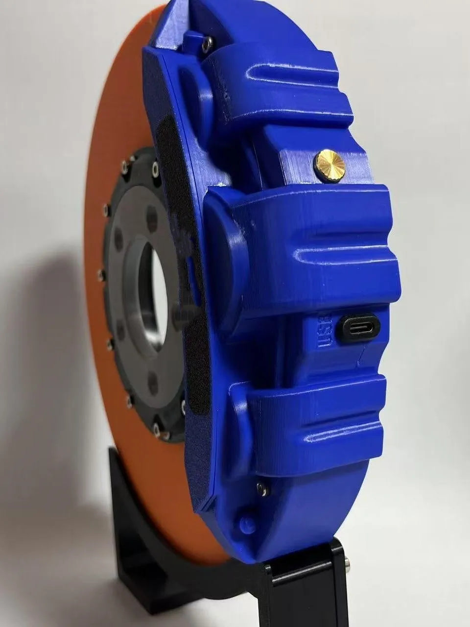 Blue brake disc LED night light with bracket on desk, showing 24cm disc and touch switch
