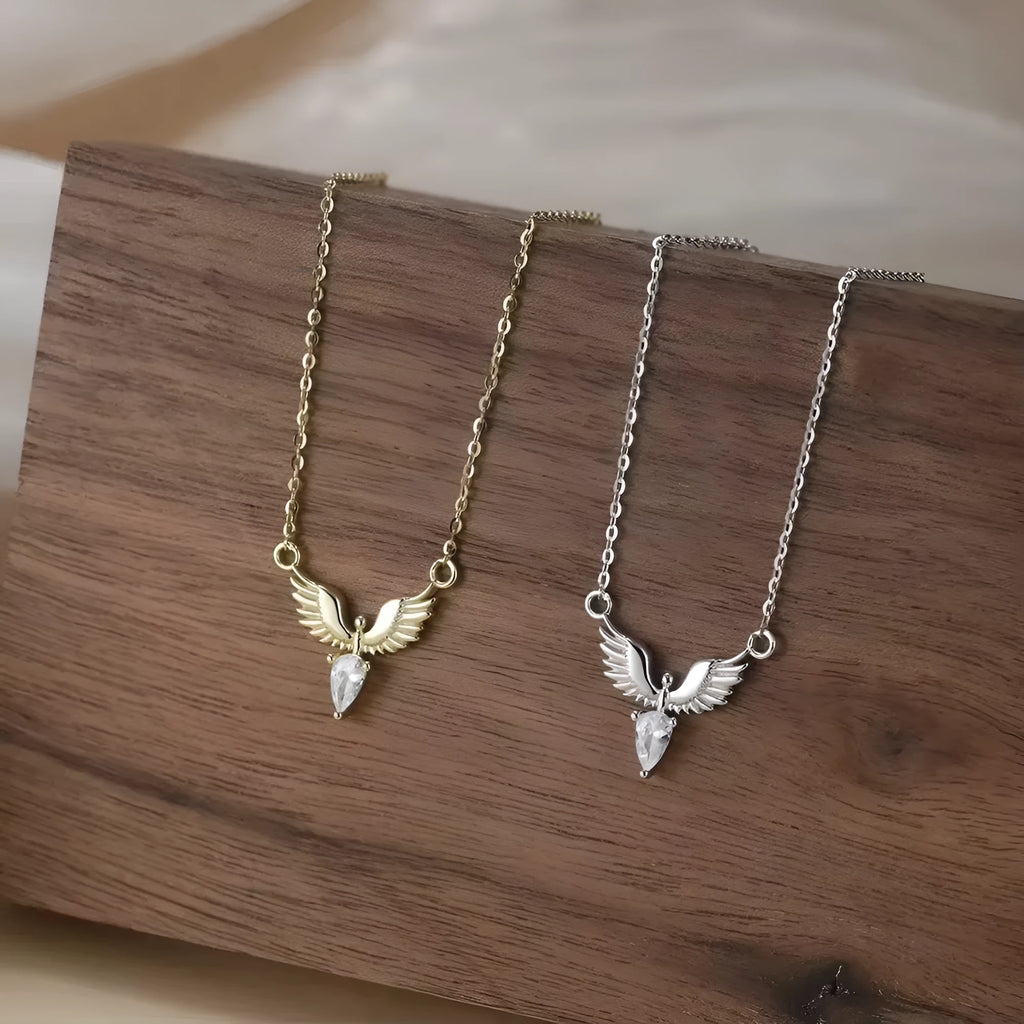 Sterling silver eagle pendant necklace on an O-ring chain, showing white gold and yellow gold colour options.