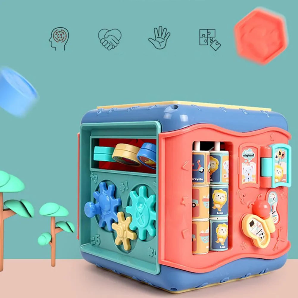 Colourful six-sided Montessori educational toy cube showing bead maze, gears, car track, clock, butterfly, and number activities