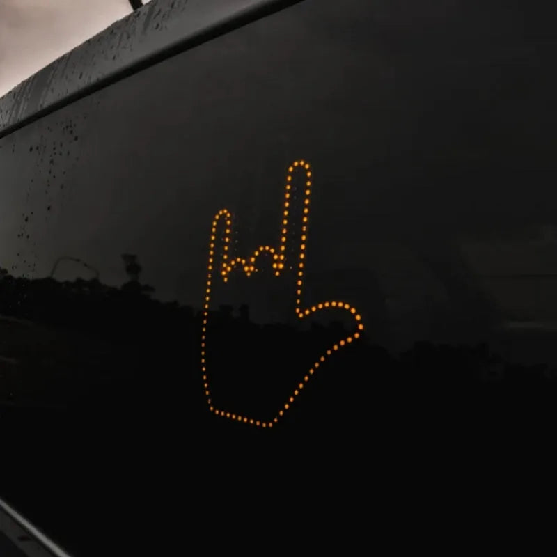 Black plastic LED gesture car light with remote control showing three-finger gesture