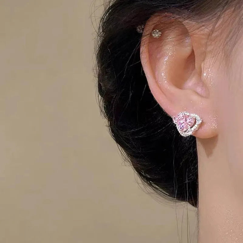 A pair of heart-shaped stud earrings with a white gold colour finish.