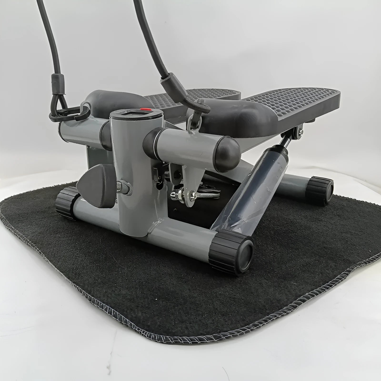 Silver grey household mini treadmill waist slimming machine with hydraulic resistance system.