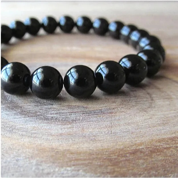 Geometric black agate bracelet with 8mm beads on elastic cord for women.