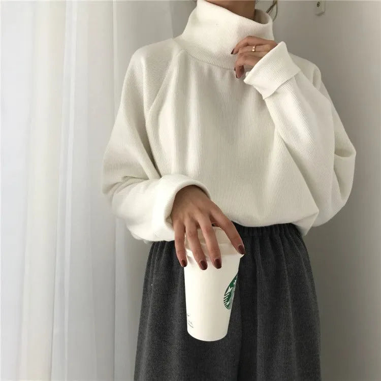 Women's solid colour loose-fit polyester top with half-high collar and long sleeves.