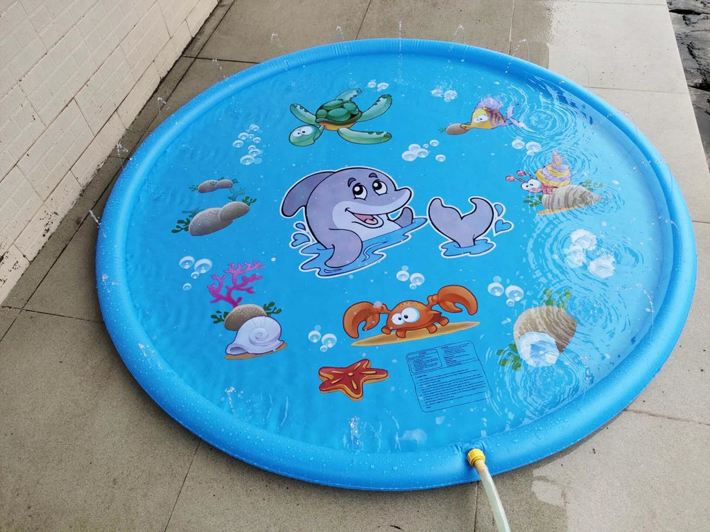 Blue PVC children's water spray pool mat with marine animal designs laid out on grass