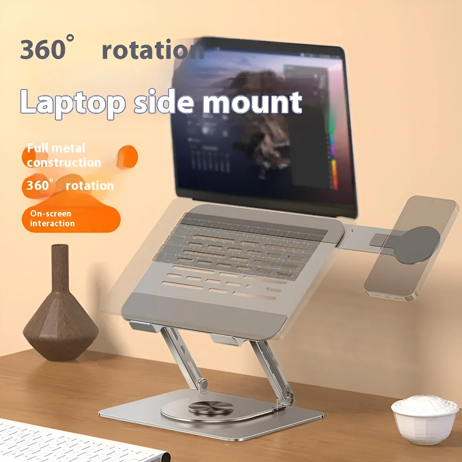 Silver carbon steel laptop stand with 360-degree rotation and a side-mounted magnetic mobile phone holder.