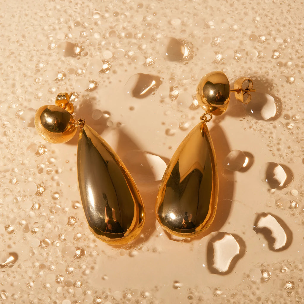 Gold electroplated stainless steel earrings with geometric hemisphere water drop pendant design