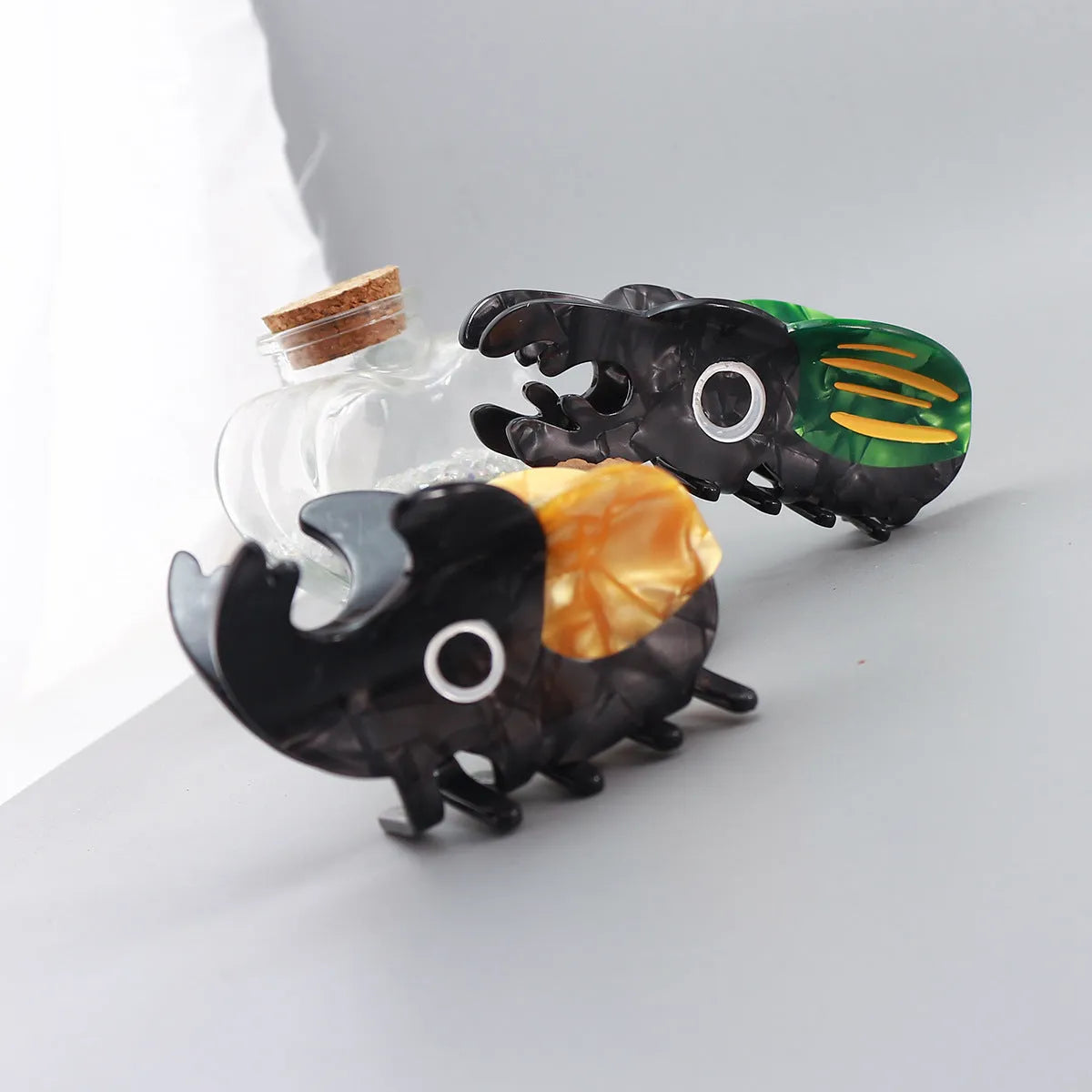 Handmade green and orange cellulose acetate beetle grip with white caterpillar cartoon design