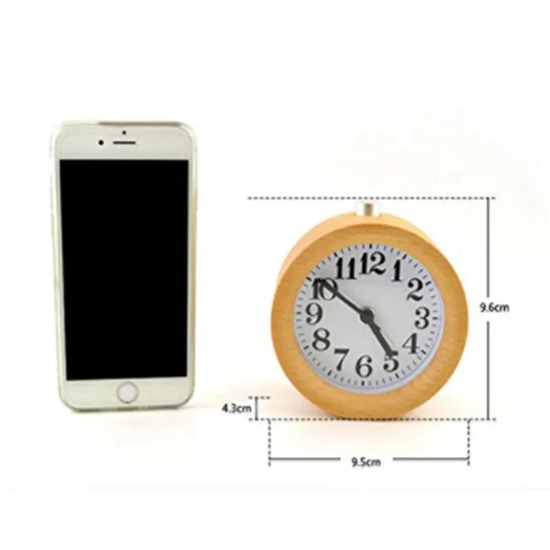 Solid beech wood silent snooze alarm clock with white dial and black numerals on a wooden surface.