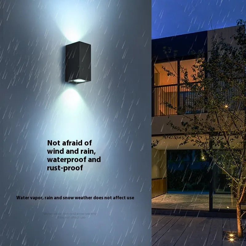 Simple modern outdoor waterproof LED wall lamp in black aluminium with glass panel for garden or patio