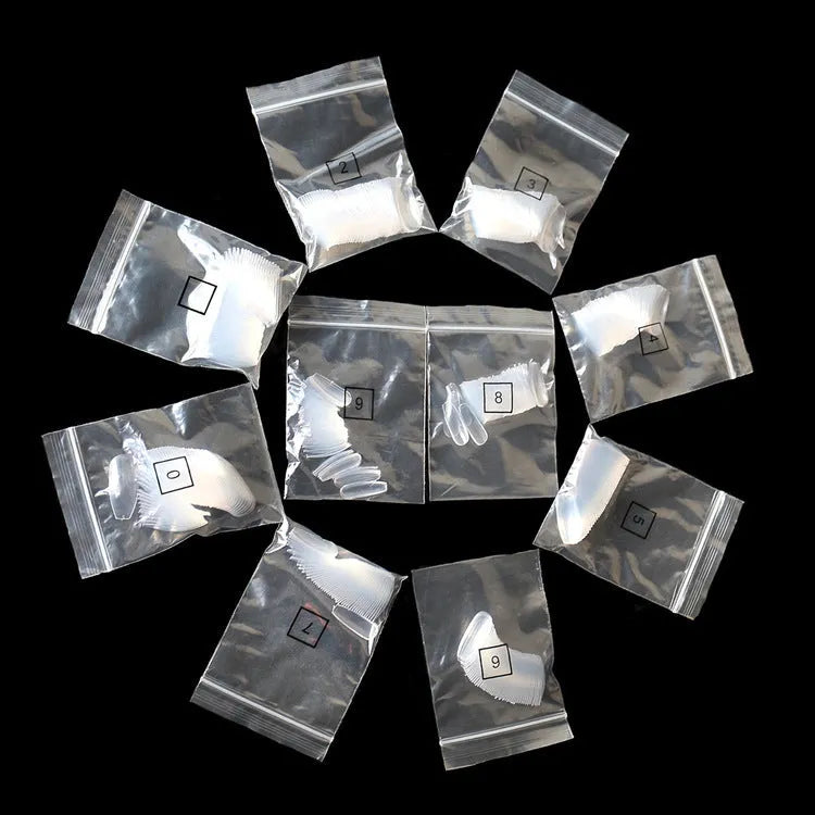 500 clear ABS false nails in 10 different sizes, laid out for professional or home manicure application