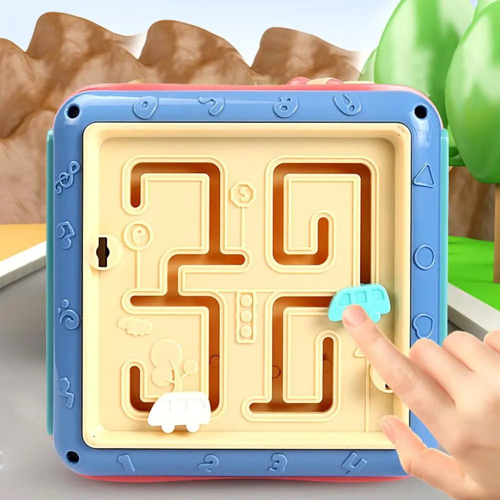 Colourful six-sided Montessori educational toy cube showing bead maze, gears, car track, clock, butterfly, and number activities