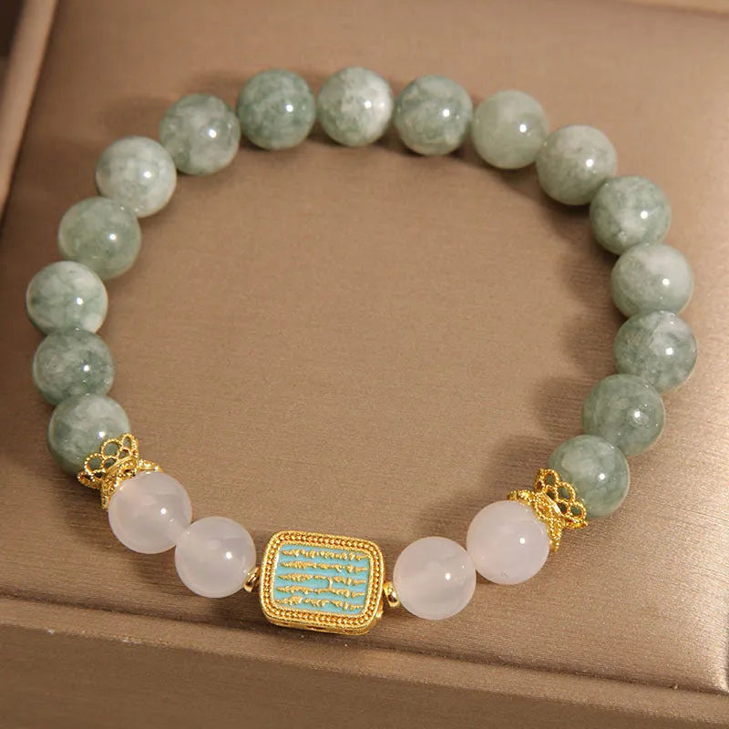 Women's oil green emerald crystal bracelet showing five scripture elements on wrist