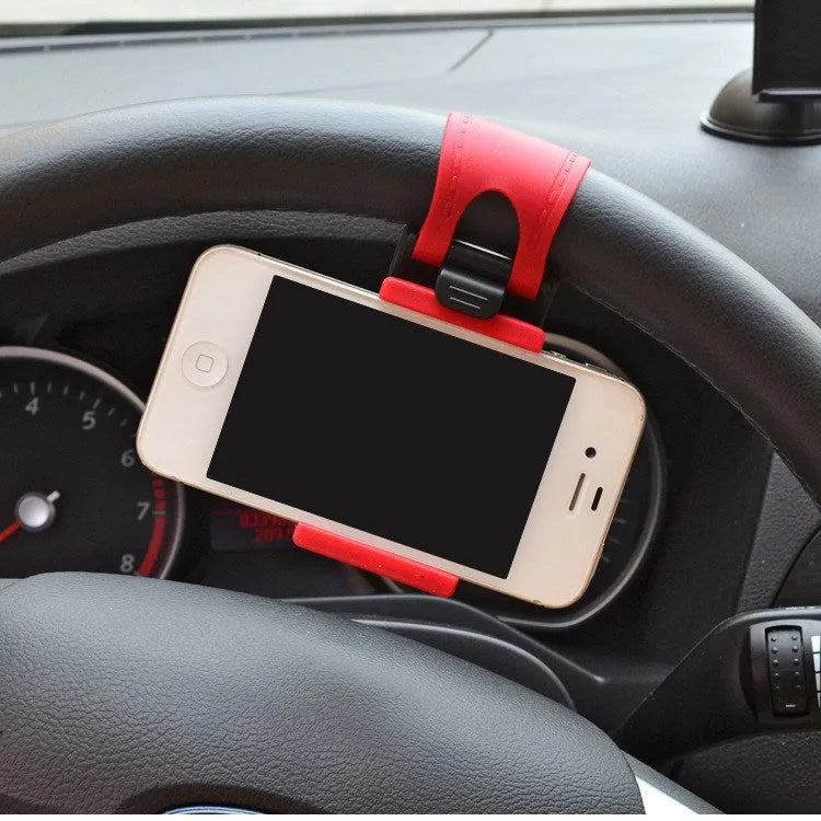 Black steering wheel phone holder clip mounted on car steering wheel holding smartphone