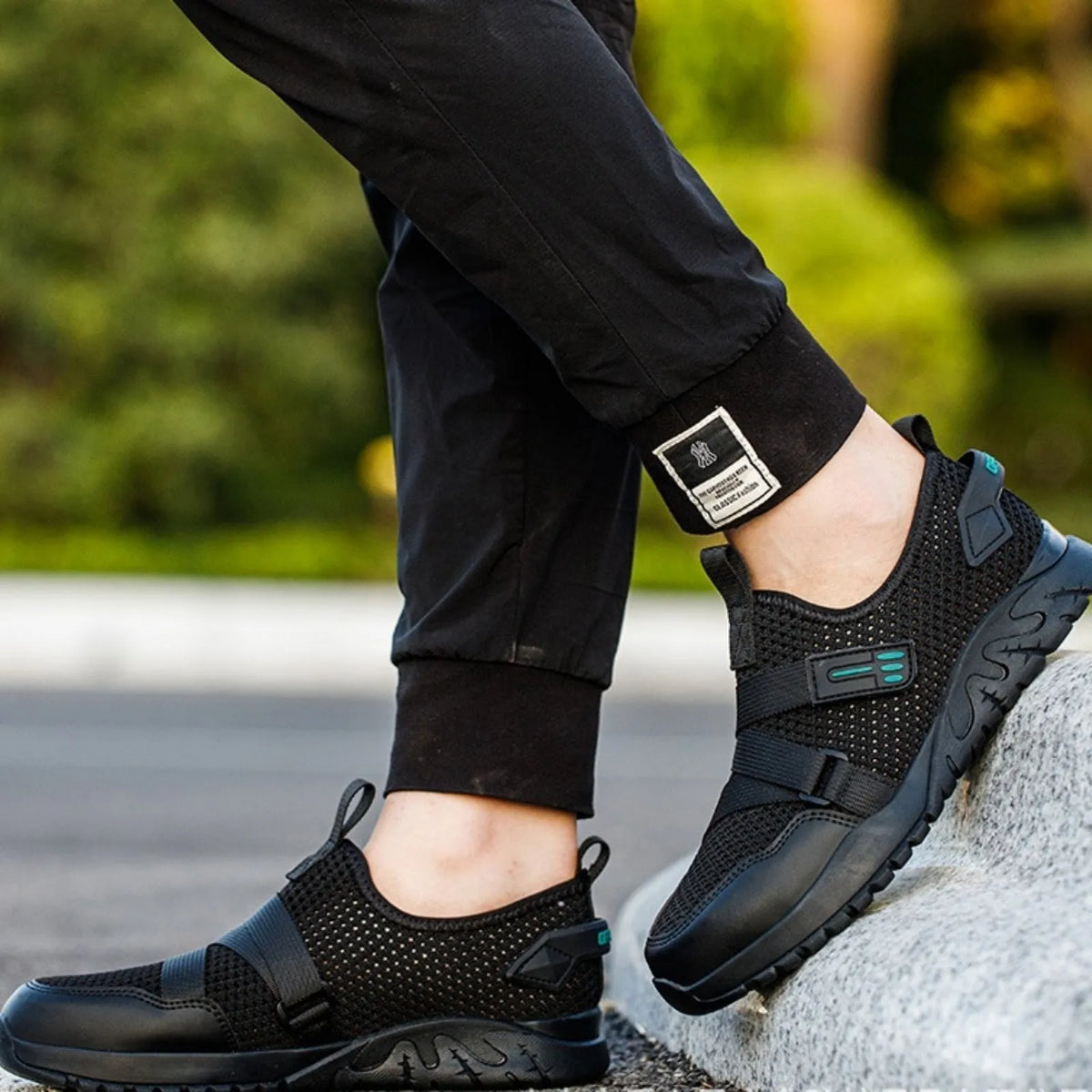 Men's grey safety shoes with steel toe caps, rubber soles, and flying woven upper construction