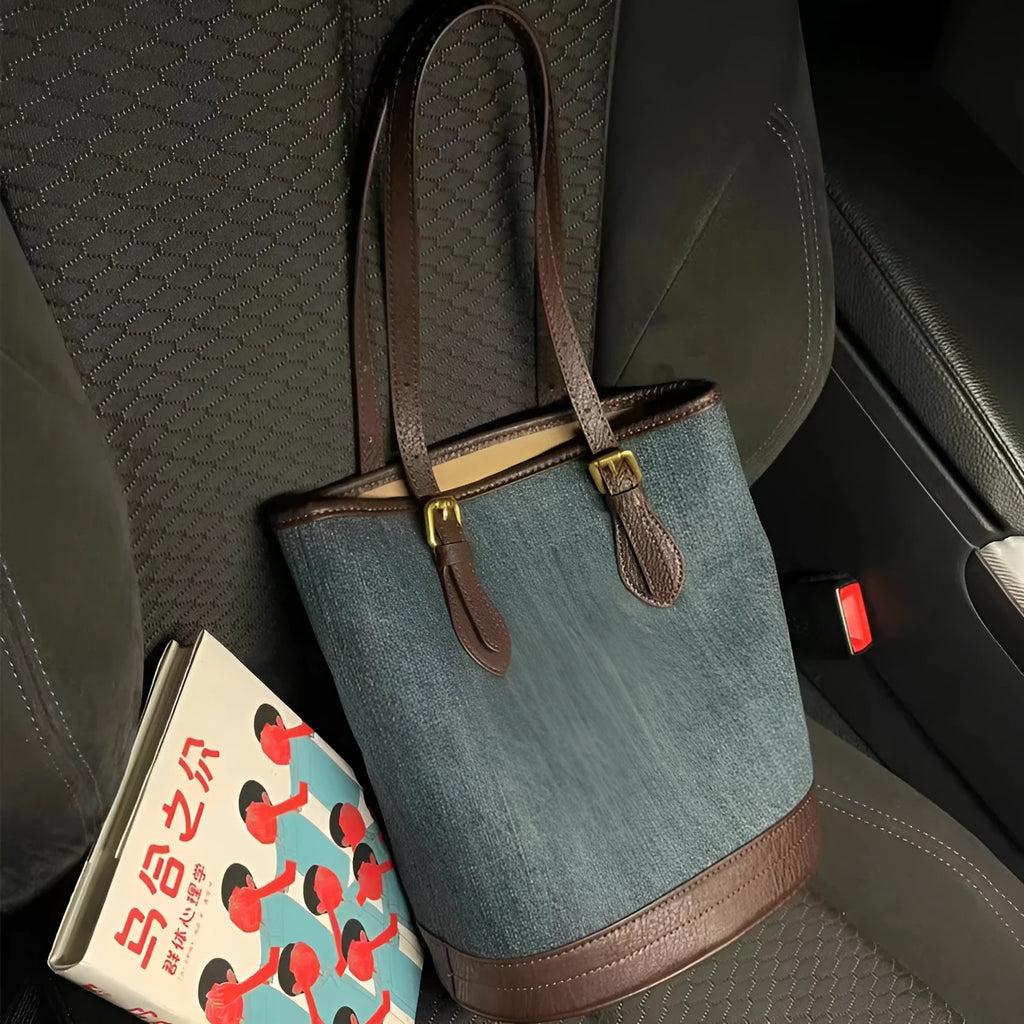 Denim patchwork one-shoulder bucket handbag showing 23x27x16cm dimensions and polyester construction