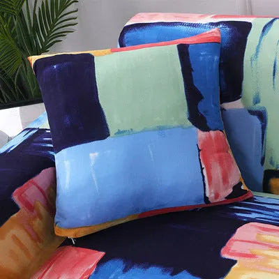 Stretchable geometric print sofa slipcover covering a three-seater sofa with matching pillow