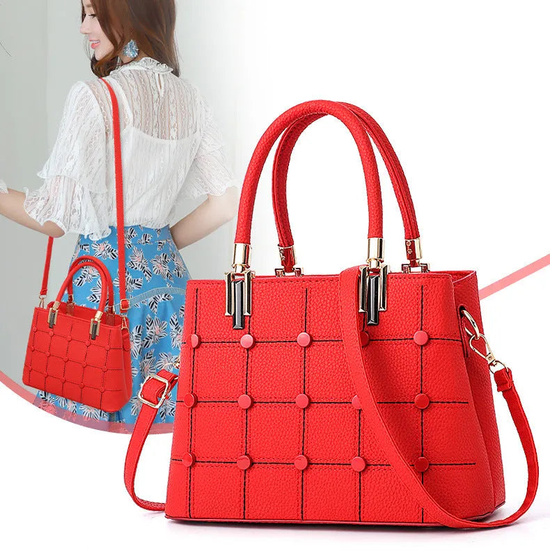 Women's handbag with rivet detailing in dark green, internal multi-pocket storage, PU outer and polyester lining