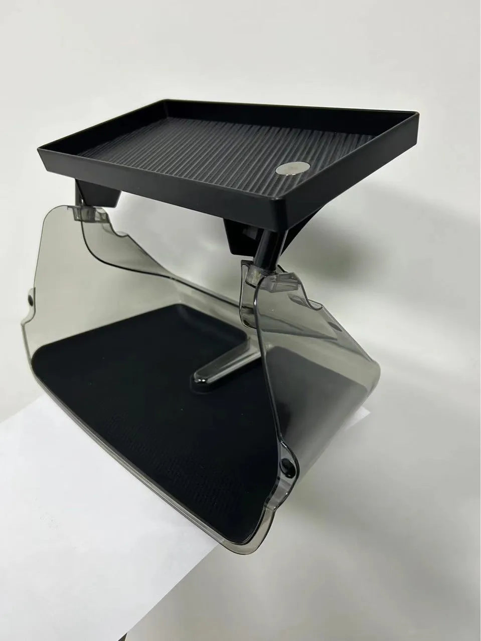 Black ABS storage box for Tesla Model 3 and Y, positioned under the centre touchscreen.