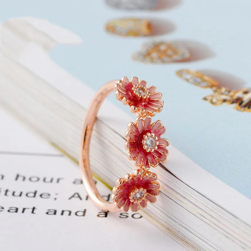 Three pink daisy rings with pink gemstone inlay in 925 sterling silver