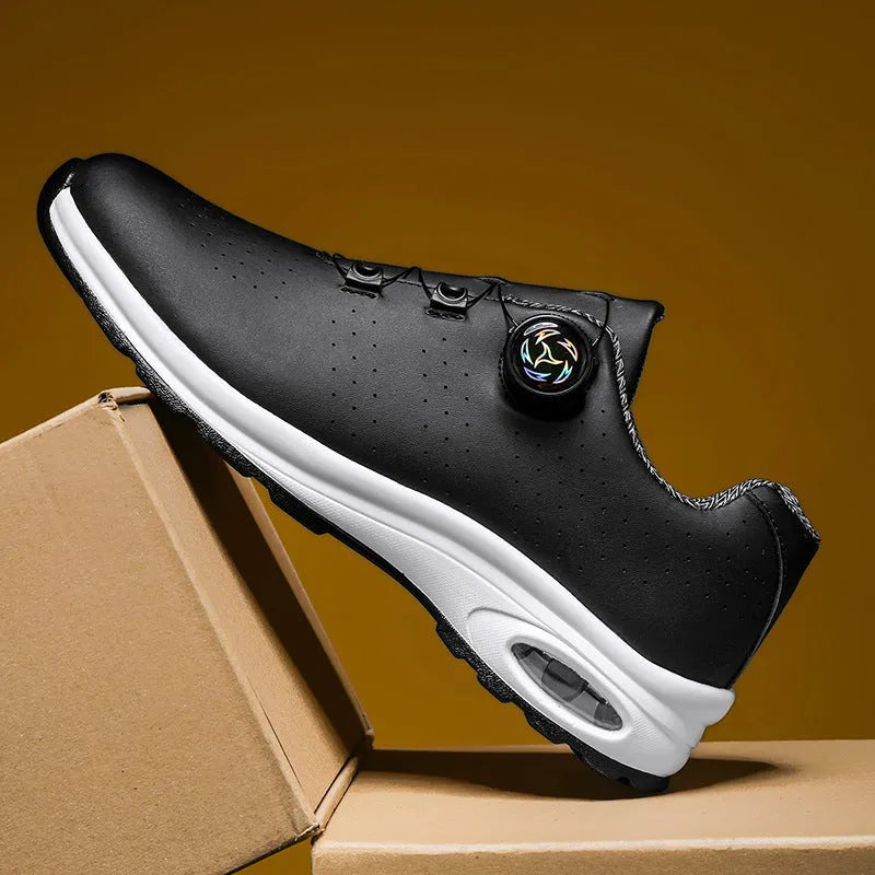 Low-top black and white mesh casual shoes with cross shoulder strap and round toe on a composite sole.