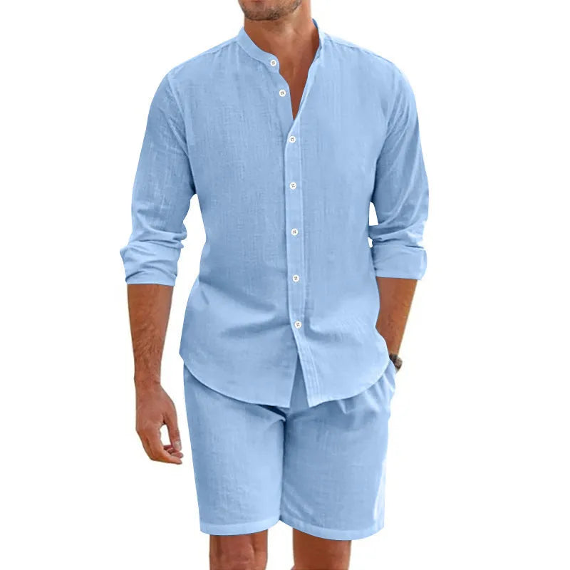 Man wearing a dark grey short-sleeve lapel shirt and matching drawstring shorts from a hemp-blend linen summer suit set.