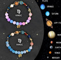 Two natural stone beaded bracelets with metal zodiac sign charms on a flat surface.