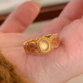 Pink crystal enamel geometric open mouth ring for women on gold-plated copper band.