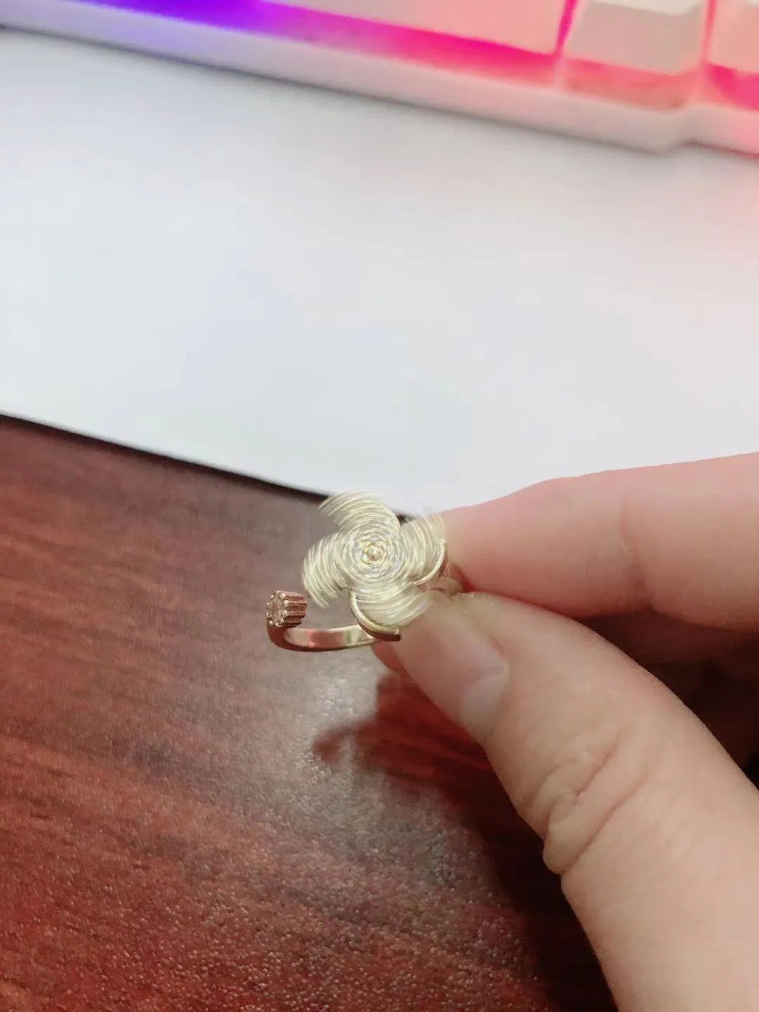 Gold and silver rotating windmill ring with geometric design