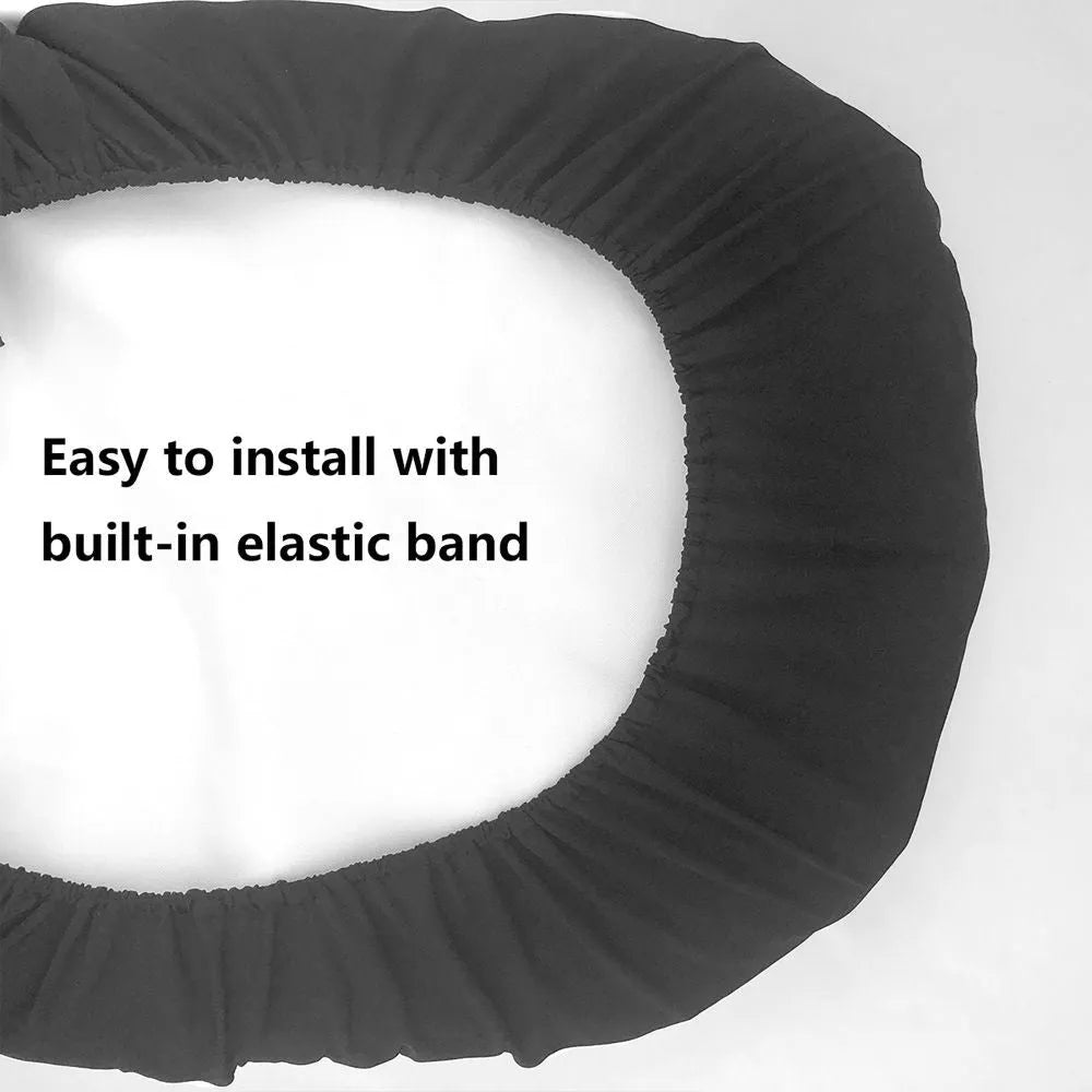 Black polyester car seat cover with elastic straps, foam padding, and rear pocket installed on a car seat